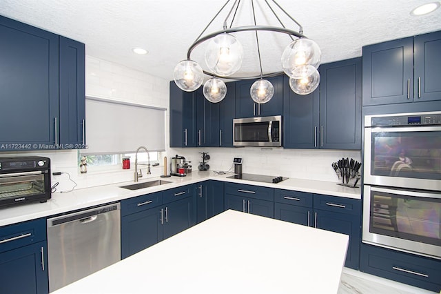 kitchen with sink, stainless steel appliances, and blue cabinets