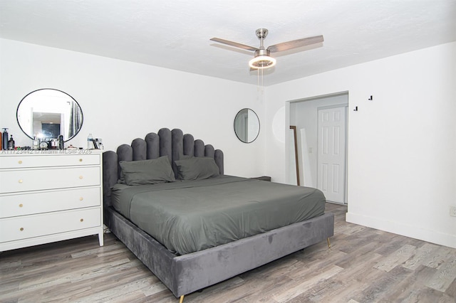 bedroom featuring hardwood / wood-style flooring and ceiling fan