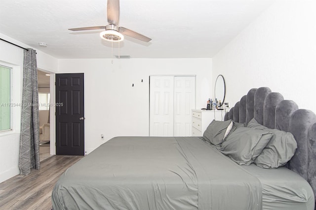 bedroom featuring a closet, ceiling fan, and light wood-type flooring