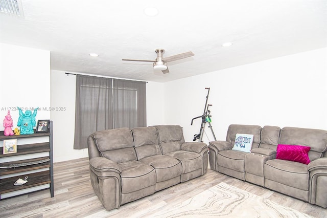 living room with ceiling fan and light hardwood / wood-style floors