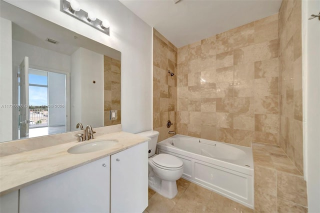 full bathroom with vanity, tiled shower / bath combo, and toilet