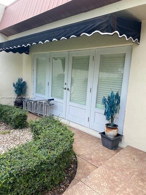 property entrance with french doors and a patio