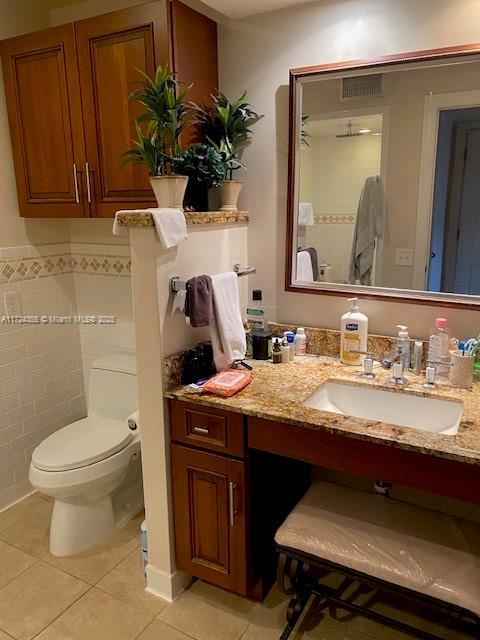 bathroom with tile patterned floors, vanity, and toilet