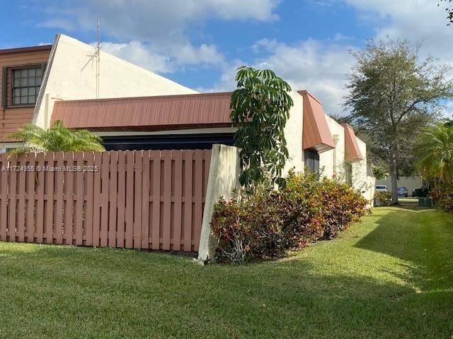 view of property exterior with a yard