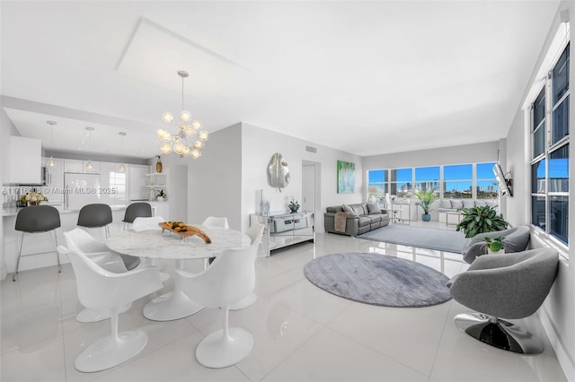 dining room with a chandelier and light tile patterned floors