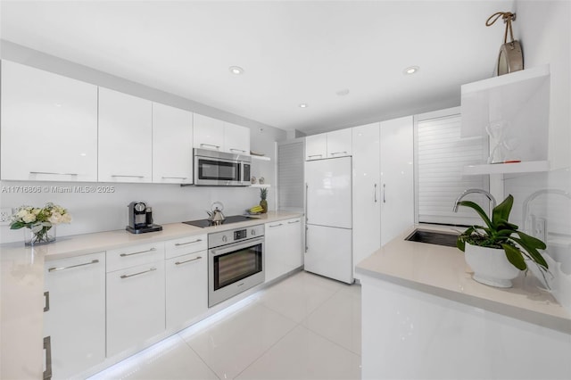 kitchen featuring light tile patterned floors, white cabinetry, appliances with stainless steel finishes, open shelves, and modern cabinets