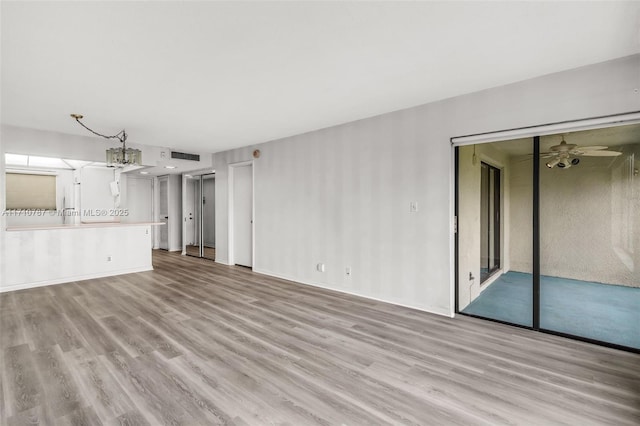 unfurnished living room featuring ceiling fan and light hardwood / wood-style flooring