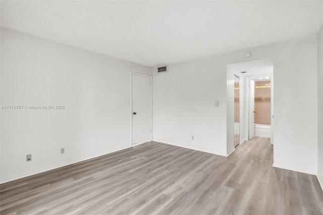 unfurnished room with light hardwood / wood-style flooring