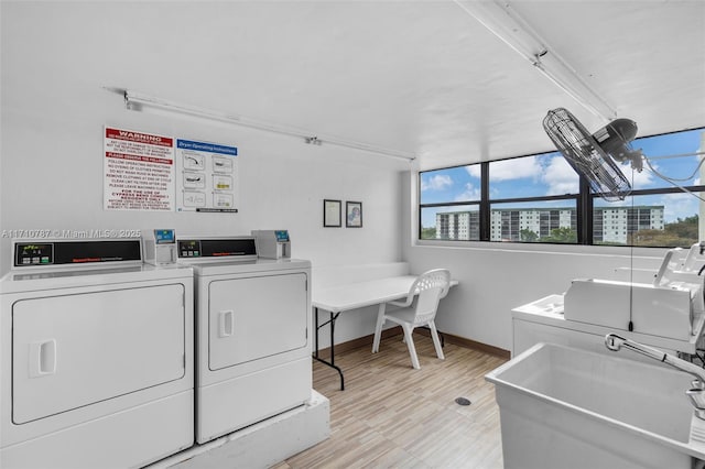 washroom featuring washing machine and clothes dryer and sink