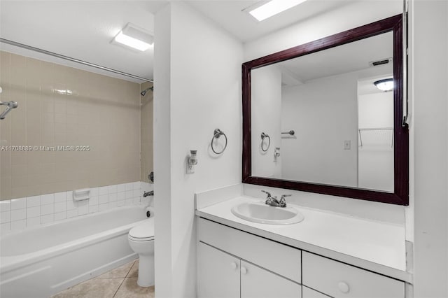 full bathroom with toilet, vanity, tile patterned floors, and tiled shower / bath