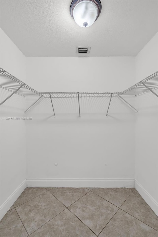 walk in closet featuring light tile patterned floors