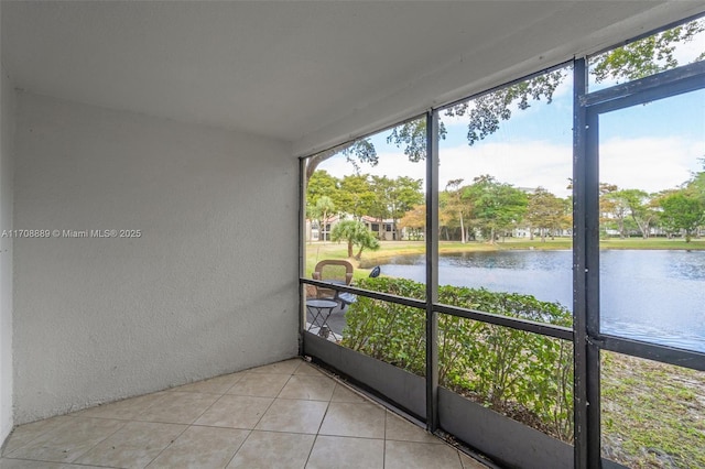 unfurnished sunroom with a water view