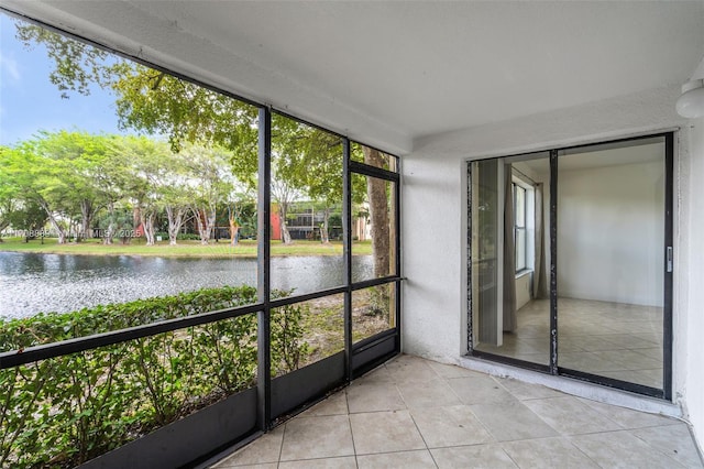 unfurnished sunroom with a healthy amount of sunlight and a water view