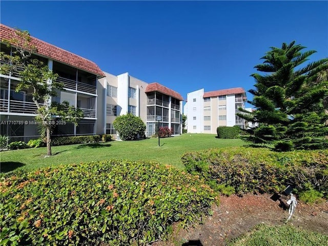 view of property's community with a lawn