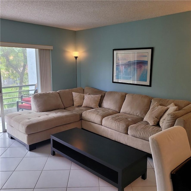 living room with a textured ceiling and light tile patterned floors