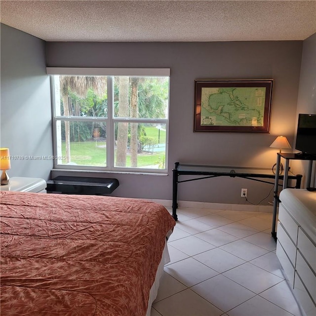 tiled bedroom with a textured ceiling