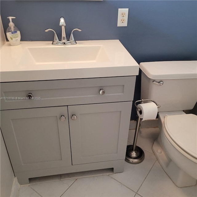 bathroom featuring toilet, tile patterned flooring, and vanity