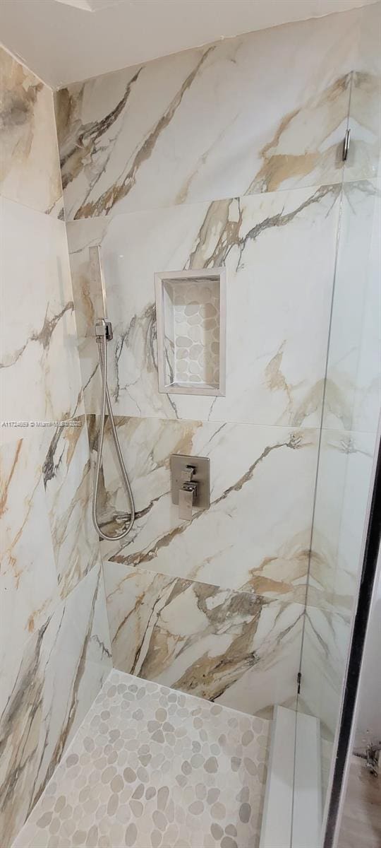 bathroom with a tile shower