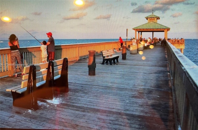 view of dock featuring a gazebo and a water view