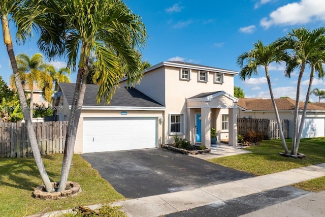 view of front of house with a front lawn and a garage