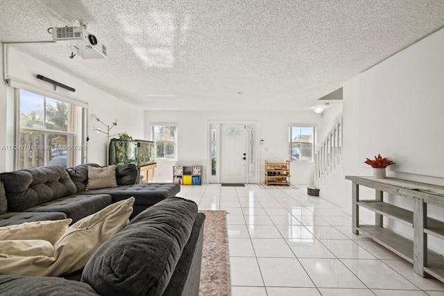 tiled living room with a textured ceiling and plenty of natural light