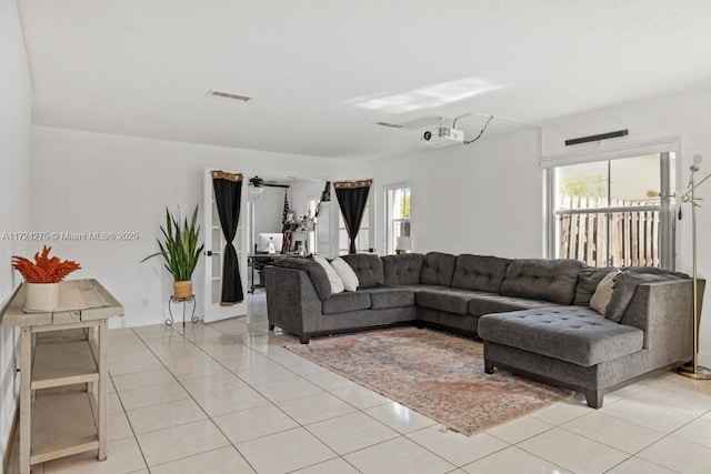 tiled living room with plenty of natural light