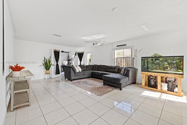 living room featuring a textured ceiling and light tile patterned flooring