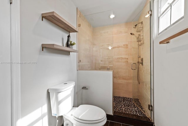 bathroom featuring toilet and walk in shower