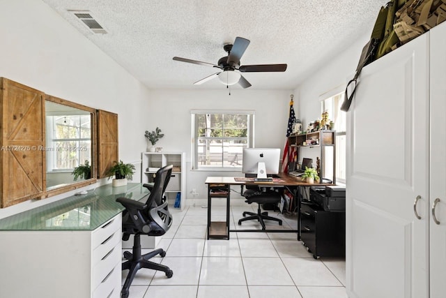 tiled home office featuring a textured ceiling and ceiling fan