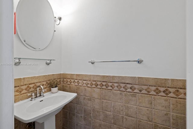 bathroom with tile walls and sink