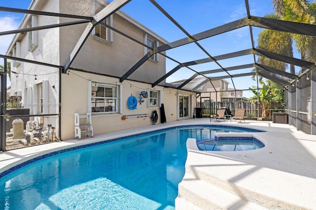 view of swimming pool with a patio area, an in ground hot tub, and glass enclosure