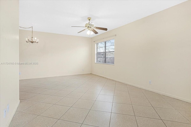 tiled empty room featuring ceiling fan with notable chandelier