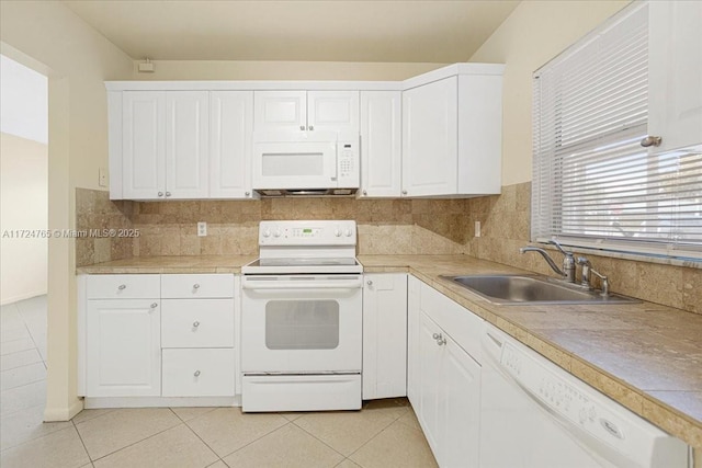 kitchen featuring white appliances, white cabinets, and sink