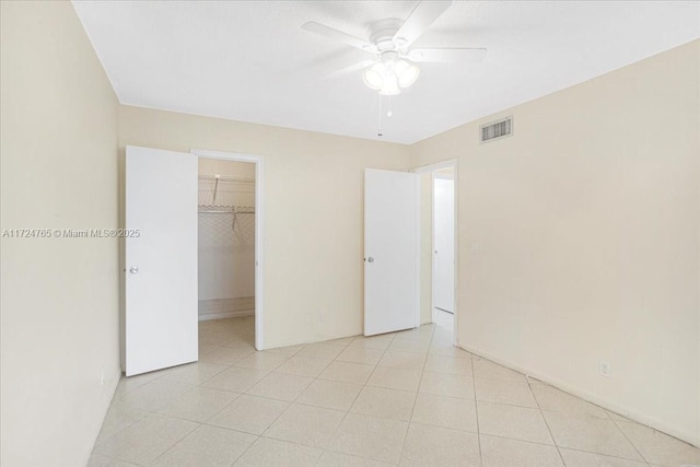 interior space featuring ceiling fan, a spacious closet, and a closet