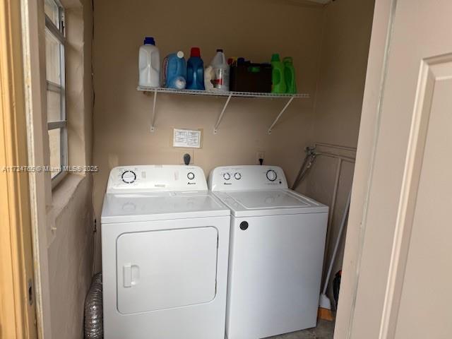 washroom featuring washer and clothes dryer