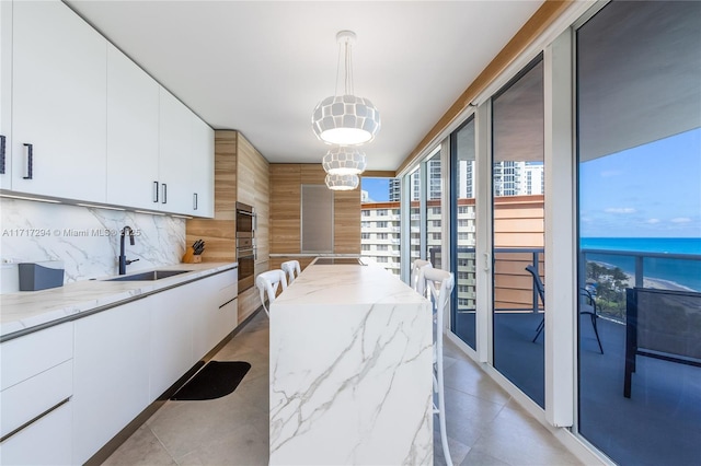 dining space with a water view and sink