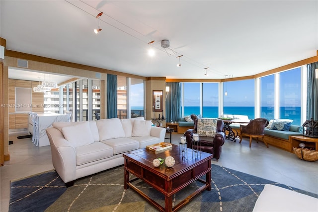 living room featuring a water view and a chandelier