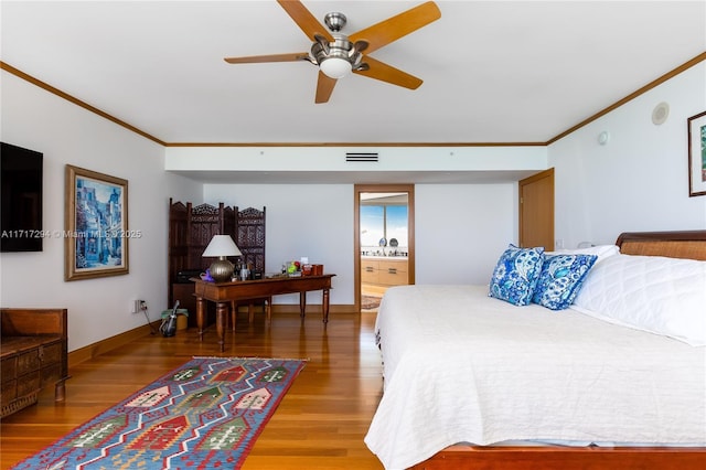 bedroom featuring ceiling fan, hardwood / wood-style floors, ornamental molding, and ensuite bathroom