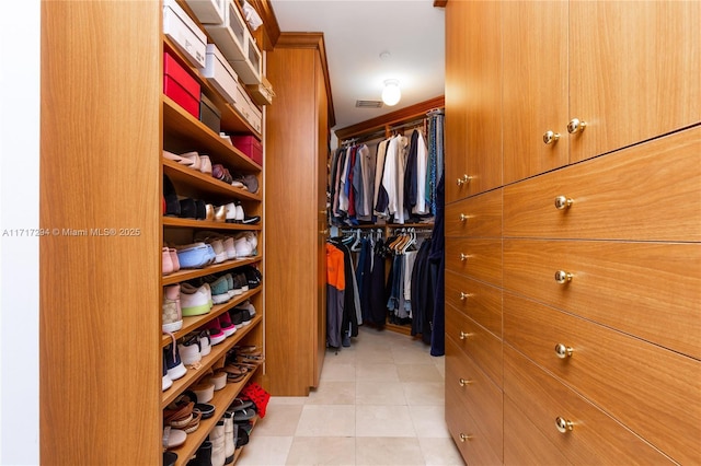 spacious closet with light tile patterned floors