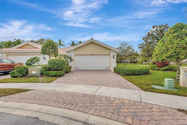 view of front of home featuring a garage and a front lawn