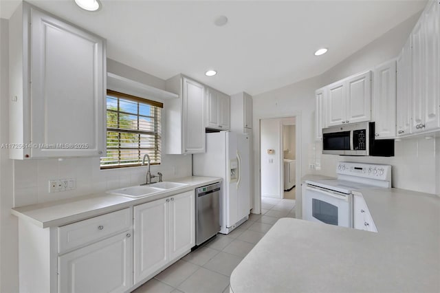 kitchen with light tile patterned floors, sink, white cabinets, and stainless steel appliances