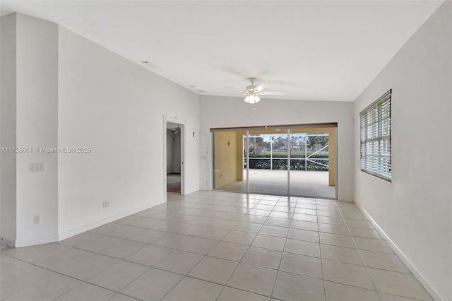 tiled spare room featuring ceiling fan