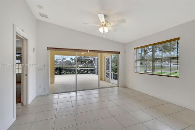 tiled spare room featuring ceiling fan and lofted ceiling