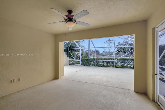 view of patio featuring ceiling fan and a lanai