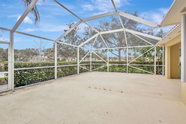 view of patio featuring glass enclosure