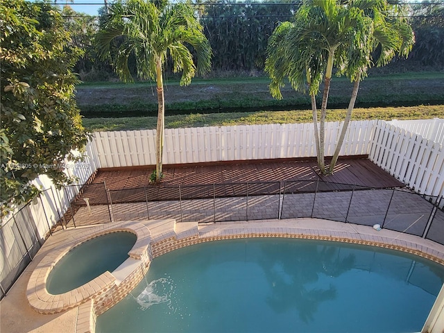 view of pool with an in ground hot tub