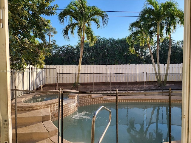 view of pool featuring an in ground hot tub