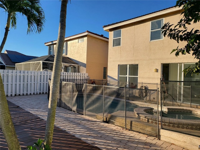 view of swimming pool with a patio and an in ground hot tub