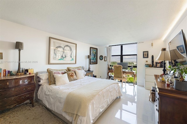 bedroom with a textured ceiling and expansive windows