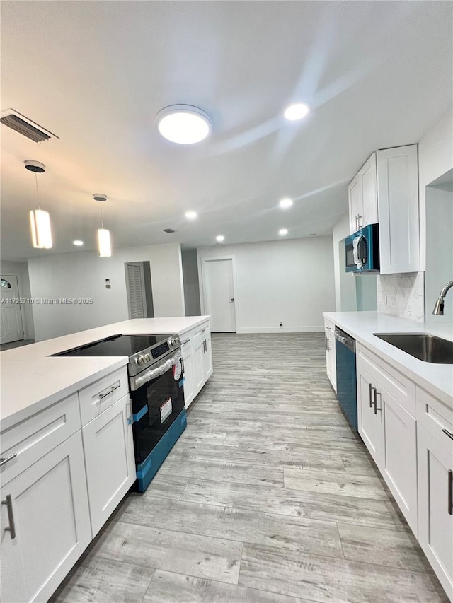 kitchen featuring white cabinetry, black dishwasher, decorative backsplash, sink, and electric range